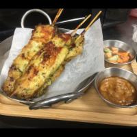 Chicken Satay · Marinated grilled chicken on skewers  served with sweet cucumber relish & peanut sauce.