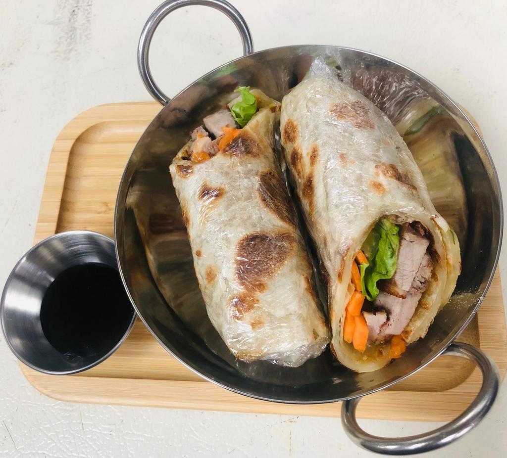 Duck Wrap · Crispy roasted duck, carrot, cucumber, celery wrapped in roti bread and served with hoisin sauce.