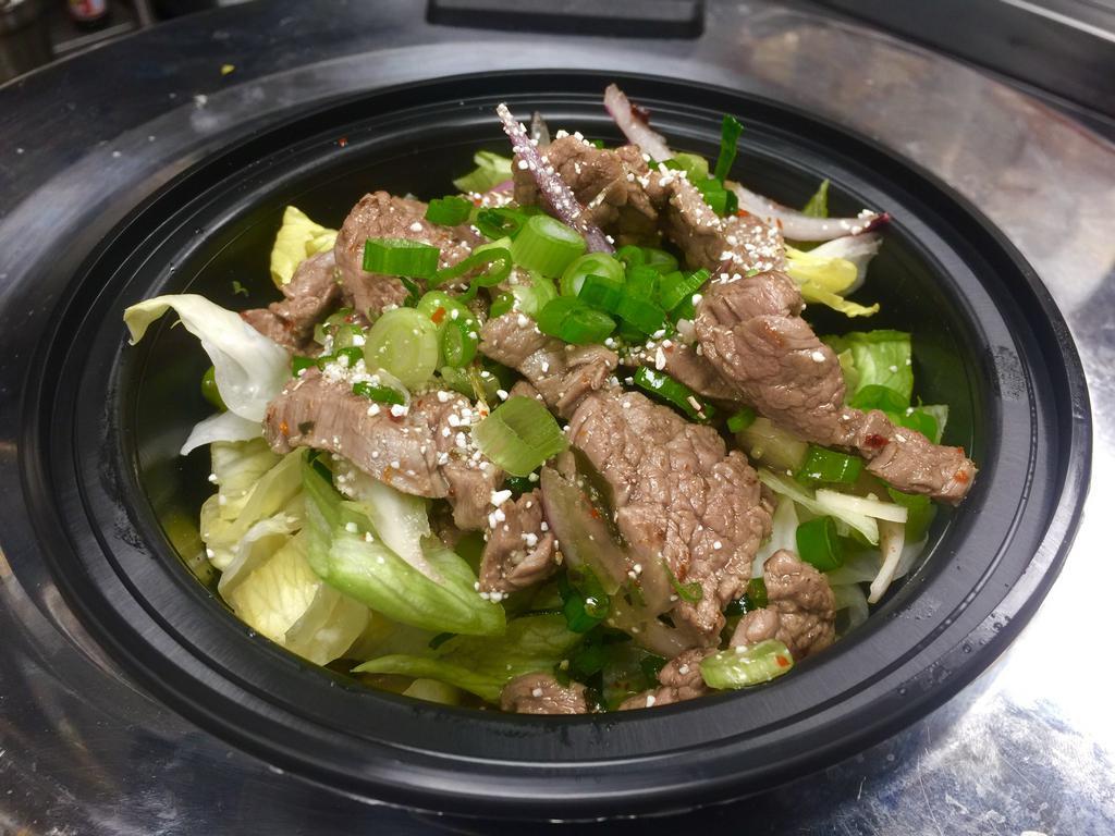 Nam Tok Beef Salad · Lettuce, scallion, shallot, lime leaf and roasted rice powder in Thai spicy dressing.