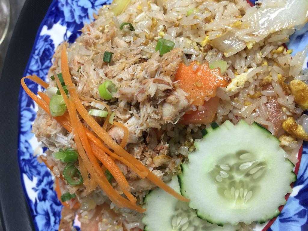 Crab Meat Fried Rice · Fried rice with onion, scallion, egg and crab meat on top.
