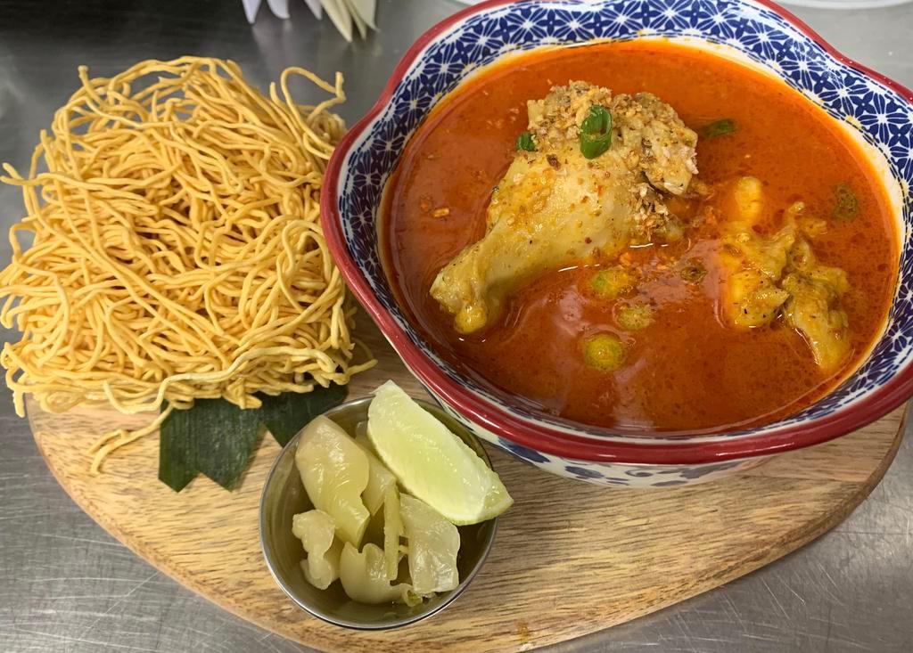 Kow Soi (medium spicy) · Medium spice with Northern homemade paste curry, fried egg noodle and Steamed egg noodle, chicken drumstick, red onion and picked cabbage.