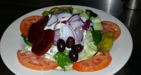 Greek Salad · Served with lettuce, feta cheese, Kalamata olives, pepperoncini, onions, tomatoes, beets and cucumbers, served with our Greek dressing. 
