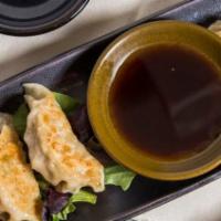 Chicken Gyoza · Japanese style dumpling with soy vinegar dipping sauce.