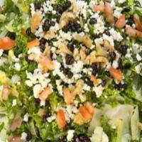 Mediterranean Salad · Mixed greens and iceberg lettuce, tomatoes, onions, raisins, chopped parsley, walnuts and cr...