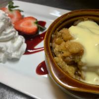 Bread Pudding · Baked sweet breads in a whiskey raisin sauce with baileys creme anglaise.