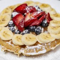 Iron Town Waffle · Belgian waffle topped with strawberries, blueberries and bananas with whipped butter and pow...