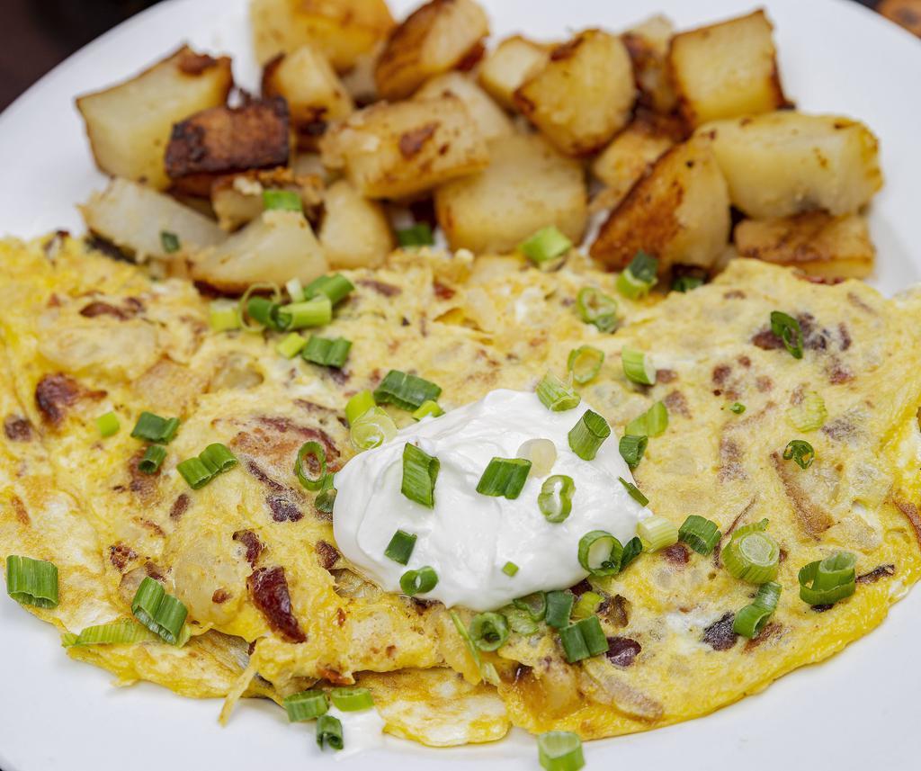 Baked Potato Omelette · Bacon bits, potato and cheddar cheese topped with sour cream and scallions.