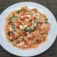Artichoke Chicken Penne · Roasted chicken, artichokes, tomatoes and spinach sautéed with tomato cream sauce. Topped wi...