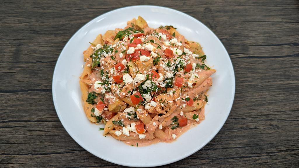 Artichoke Chicken Penne · Roasted chicken, artichokes, tomatoes and spinach sautéed with tomato cream sauce. Topped with feta cheese.
