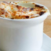 Bowl of French Onion Soup · A savory broth with onions topped with Swiss and Parmesan cheese and croutons. 