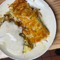 Country Omelette · Filled with bacon, onions, hash browns, cheddar cheese and country gravy on top ham and chee...