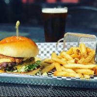 The Proud Stout Burger · Two 1/4 lb griddle-seared Angus patties with smoked gouda, American cheese and shredded lett...