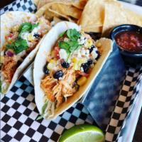 Spicy Chicken Tacos · Two chicken tinga tacos with cilantro slaw, Cotija cheese, black bean-cilantro corn, chipotl...