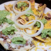 Panchos · Crisp tostadas covered with refried beans, melted cheese, guacamole, and your choice of meat...