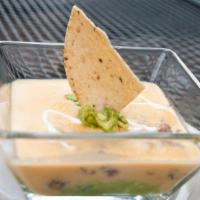 Davy Dip · A delicious layering of seasoned beef, fresh guacamole, and our famous chile con queso. 