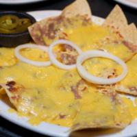 Bean and Cheese Nachos · Crisp tostadas covered with refried beans and melted cheese.  Topped with onion rings and se...