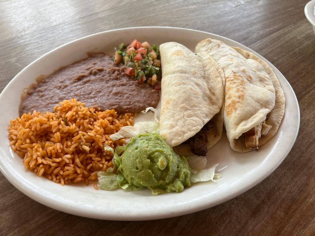Fajita Dinner · Two warm soft flour tortillas stuffed with beef or chicken fajita meat.  Served with rice, refried beans, pico de gallo, and fresh guacamole.