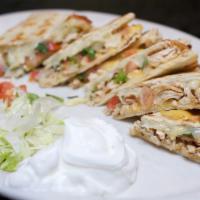 Grilled Quesadillas · Tender beef or chicken fajita meat, American, and monterey jack cheeses, and fresh pico de g...