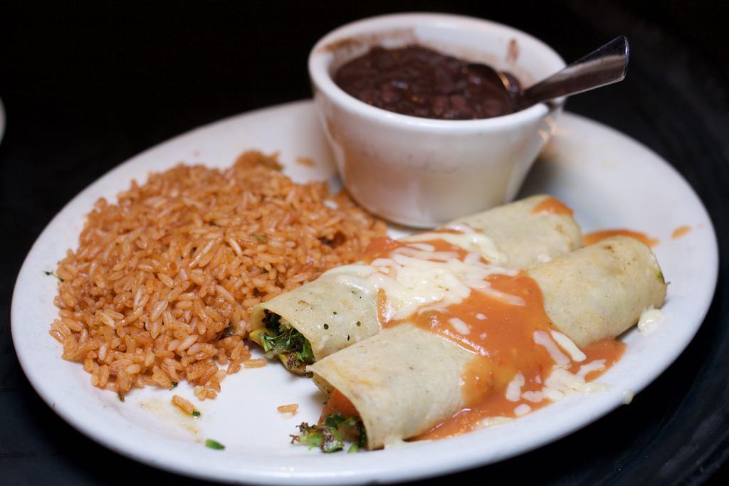 Vegetable Enchiladas  · A mix of lightly seasoned grilled veggies and melted Chihuahua cheese rolled inside soft corn tortillas and sauce topped with a mild red sauce. Served with black beans and rice.