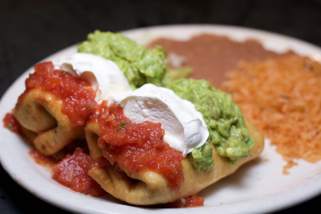 Chimichanga Dinner · Char-broiled Chicken Breast or Beef and Monterey Jack cheese stuffed inside crisp golden tortillas, and topped with guacamole, sour cream, and salsa. Served with rice and refried beans.