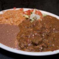 Carne Guisada Dinner · Spicy Mexican-style beef stew.  Served with rice and refried beans.