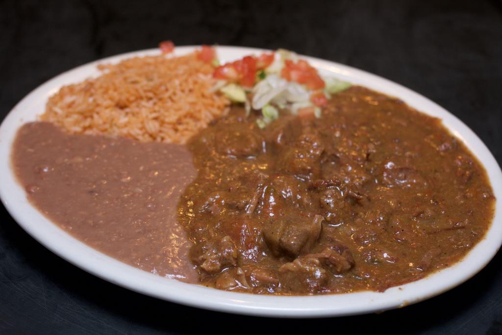 Carne Guisada Dinner · Spicy Mexican-style beef stew.  Served with rice and refried beans.