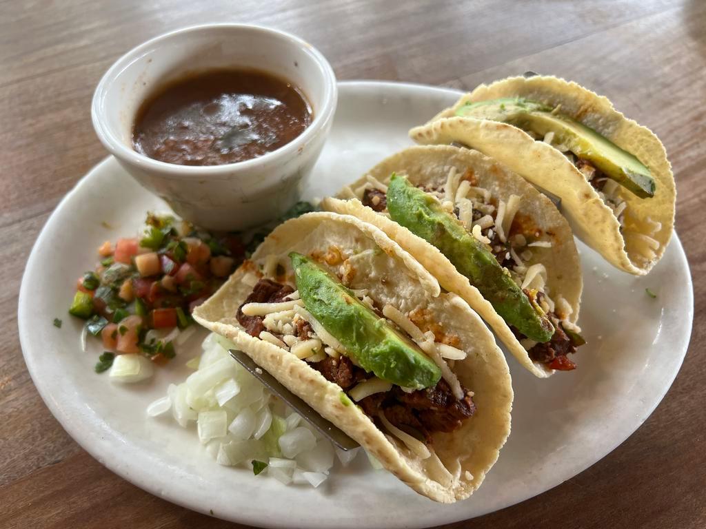 Street Taco Dinner · Alamo Cafe favorite. Beef fajita meat, tossed in chipotle sauce and pico de gallo. Served in three corn tortillas with jalapeño jack cheese, cilantro, diced onion and avocado slices. Served with borracho beans.