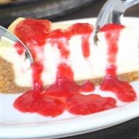 Strawberry Cheesecake  · Vanilla cheesecake topped with sliced strawberries in a strawberry syrup.  