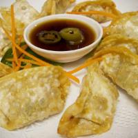 Chicken Dumplings · 8 pieces. Steamed or fried and served with tasty vinaigrette sauce.