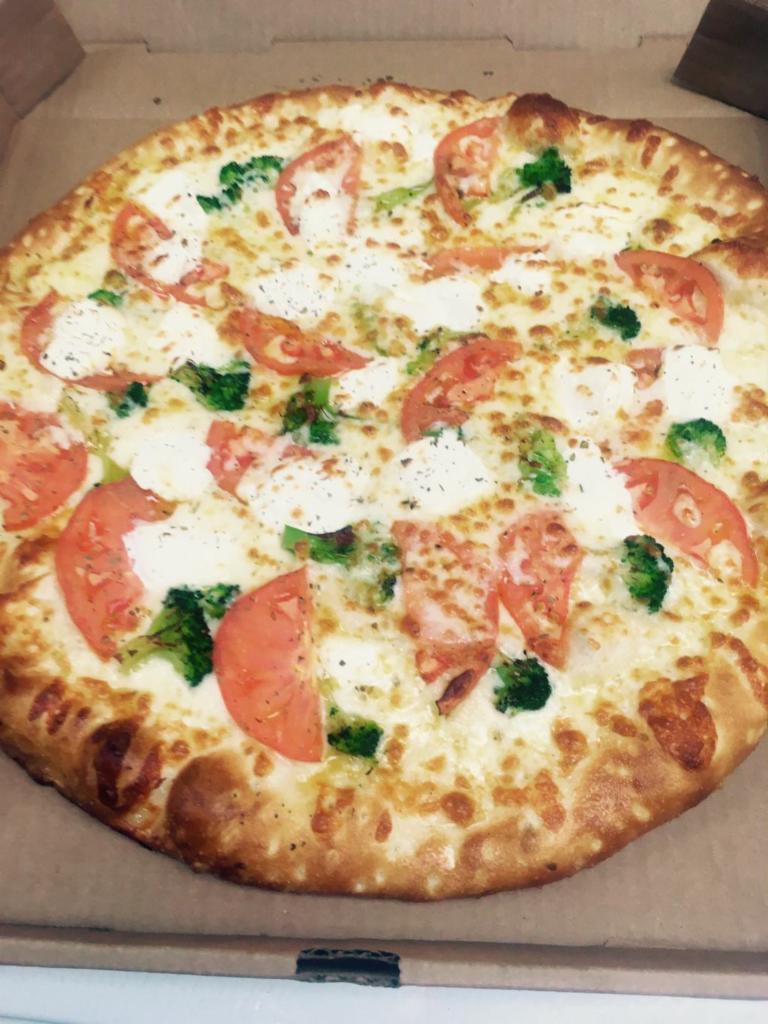 Italian White Pizza · Garlic sauce, olive oil, oregano, tomatoes, broccoli, ricotta and mozzarella cheese.