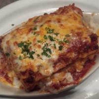 1/2 Signature Meat Lasagna · Our Italian sausage, Italian beef, pepperoni and salami with Ernesto’s meat sauce and blend ...