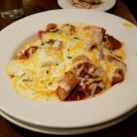 Jackie's Baked Rigatoni · Rigatoni pasta tossed in our house meat sauce topped by Alfredo then baked with our signatur...