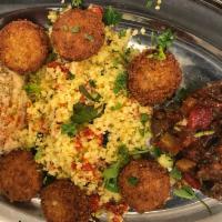 Sabra Platter · Combination of Mediterranean appetizers: hummus, falafel, cabonada and couscous with homemad...
