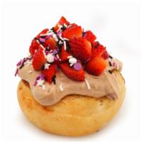 Sparkle Berry Roll · chocolate frosting topped with sprinkles and fresh strawberries (sprinkle colors may vary)