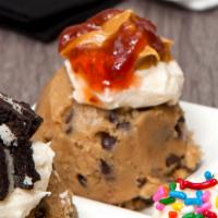 Cookie Dough Scoop - PB&J · our homemade cookie dough topped with a dollop of peanut butter frosting and a drizzle of st...