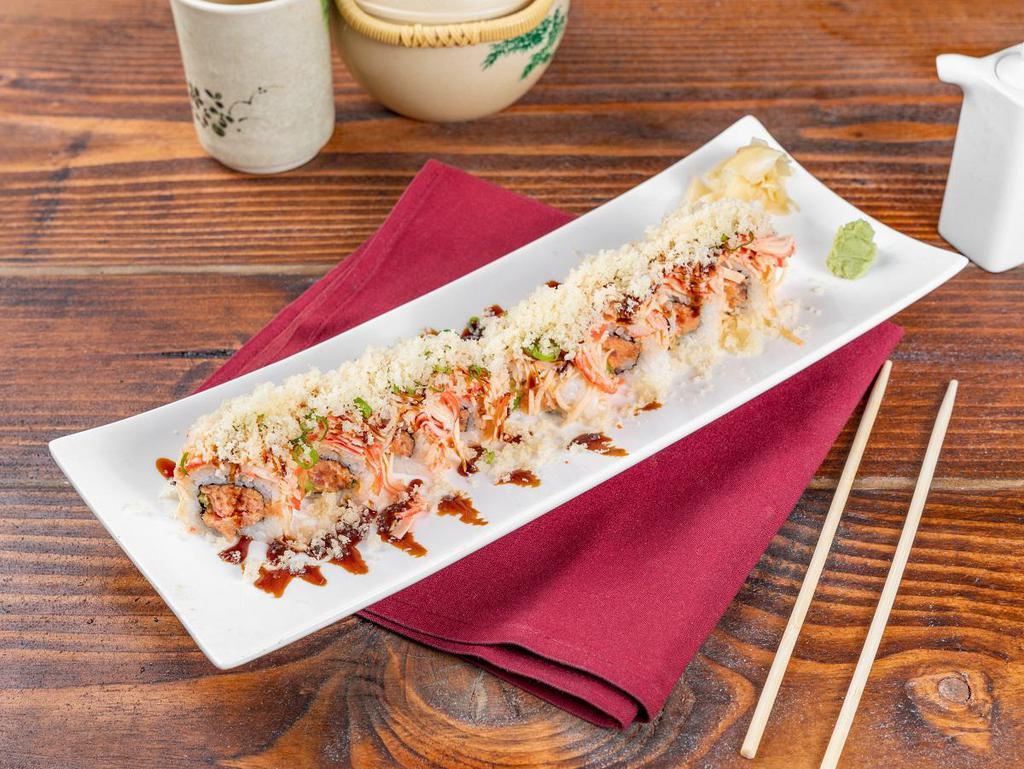 East Roll · Spicy tuna, avocado, topped with kani salad, scallion, crunch, masago and eel sauce.