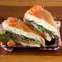 Lomo Especial Torta · Lomo is shredded beef prepared in a chipotle sauce, ham, tomato, spring mix, red onion, guac...