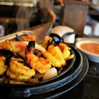 Jheenga Tandoori · Jumbo shrimp marinated with a hint of garlic and slowly broiled in the tandoor. Item served ...