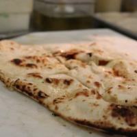 Buttered Naan · Leavened bread of fine flour baked in the tandoor.