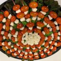 Caprese Tray · Grape Tomatoes and fresh mozzarella skewered and drizzled with a balsamic glaze. (Serves 40-...
