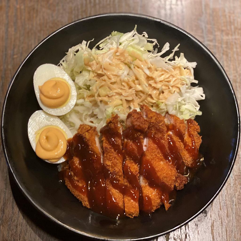 Chicken Katsu Bowl · A chicken cutlet fried katsu style and a hard-boiled egg with chili mayo served on a bed of shredded cabbage and white rice. Katsu sauce and Gyu-Kaku dressing included on the side.