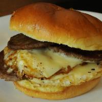 Sausage (Pork), Egg and Cheese Sandwich · 2 fried eggs, sausage and American cheese served on a kaiser roll.