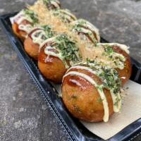 Takoyaki · popular stret food from Osaka with bits of octopus and dough inside a slightly crispy shell,...