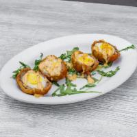 Scotch Egg  · A true British classic. A hard boiled egg, wrapped in ground pork sausage then breaded and d...
