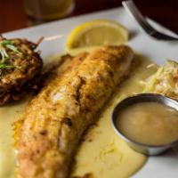 Pan Fried Walleye · House seasoned walleye topped with a cream sauce and served with a potato pancake croquette,...