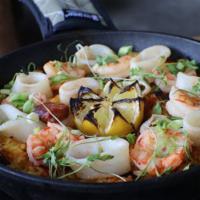 Seafood Paella · Bomba rice, sweet peas, peppers, calamari, mussels, shrimp, chorizo, saffron, scallions, cil...