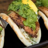 Fish Tacos · 3 tacos, seared or fried white fish, guacamole, slaw, chimichurri, cilantro, naan taco shell