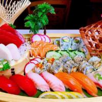 E4. Sushi Boat For 2 · 8 pieces sushi, 8 pieces sashimi and a California roll, and a shrimp tempura roll.
