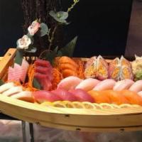 E5. Love Boat · 12 pieces sushi, 12 sashimi, and a shrimp tempura roll and low roll.