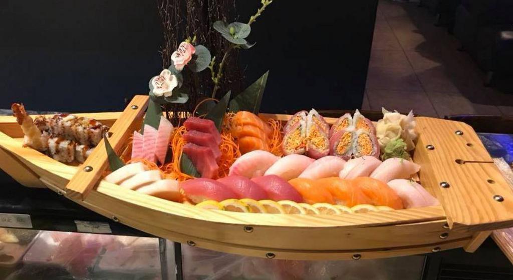 E5. Love Boat · 12 pieces sushi, 12 sashimi, and a shrimp tempura roll and low roll.